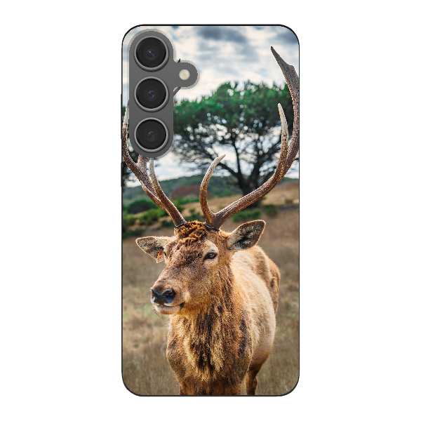deer on brown grass field under gray cloudy sky